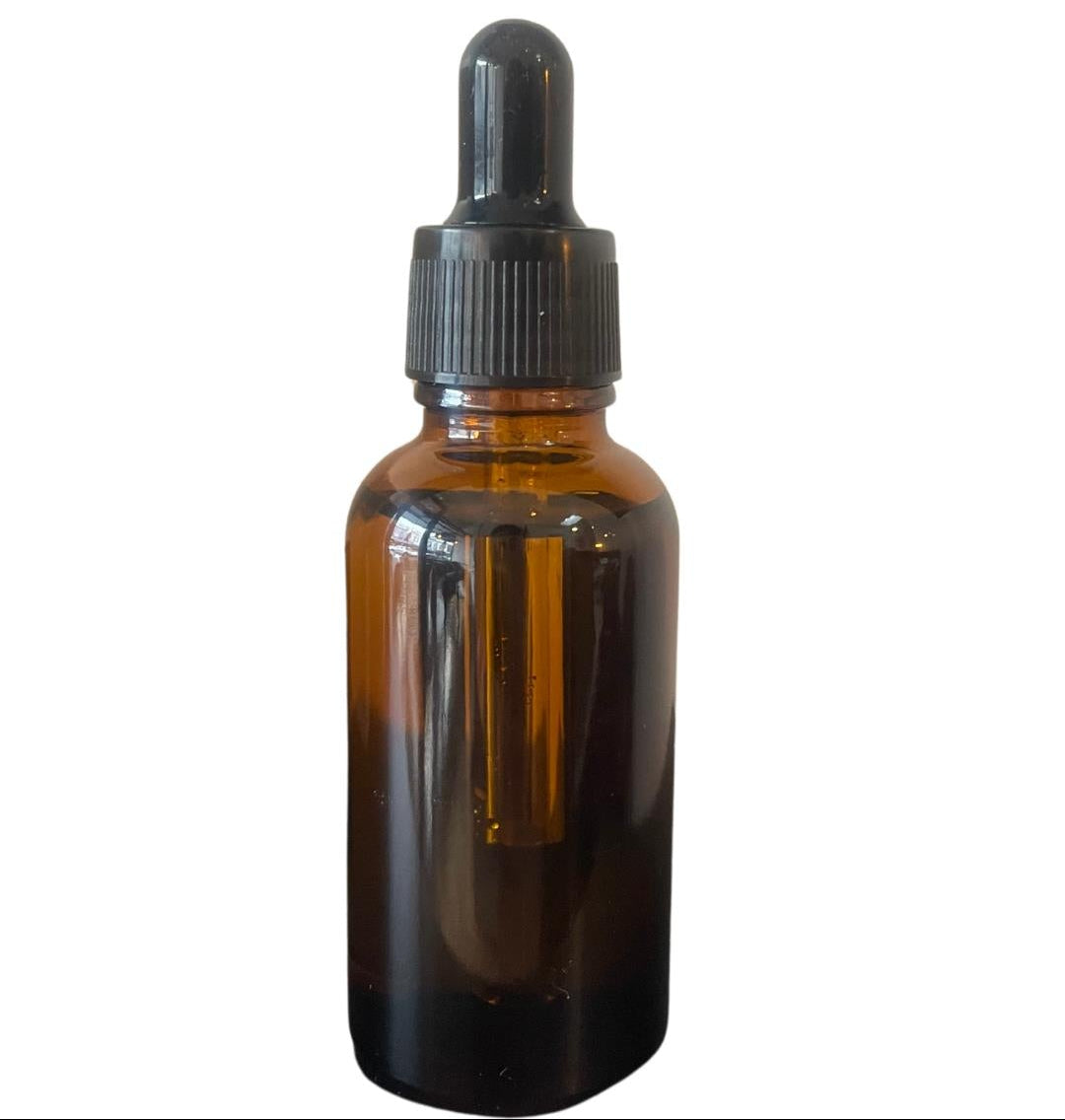 Milk Nails cuticle oil in an amber glass bottle with a black dropper